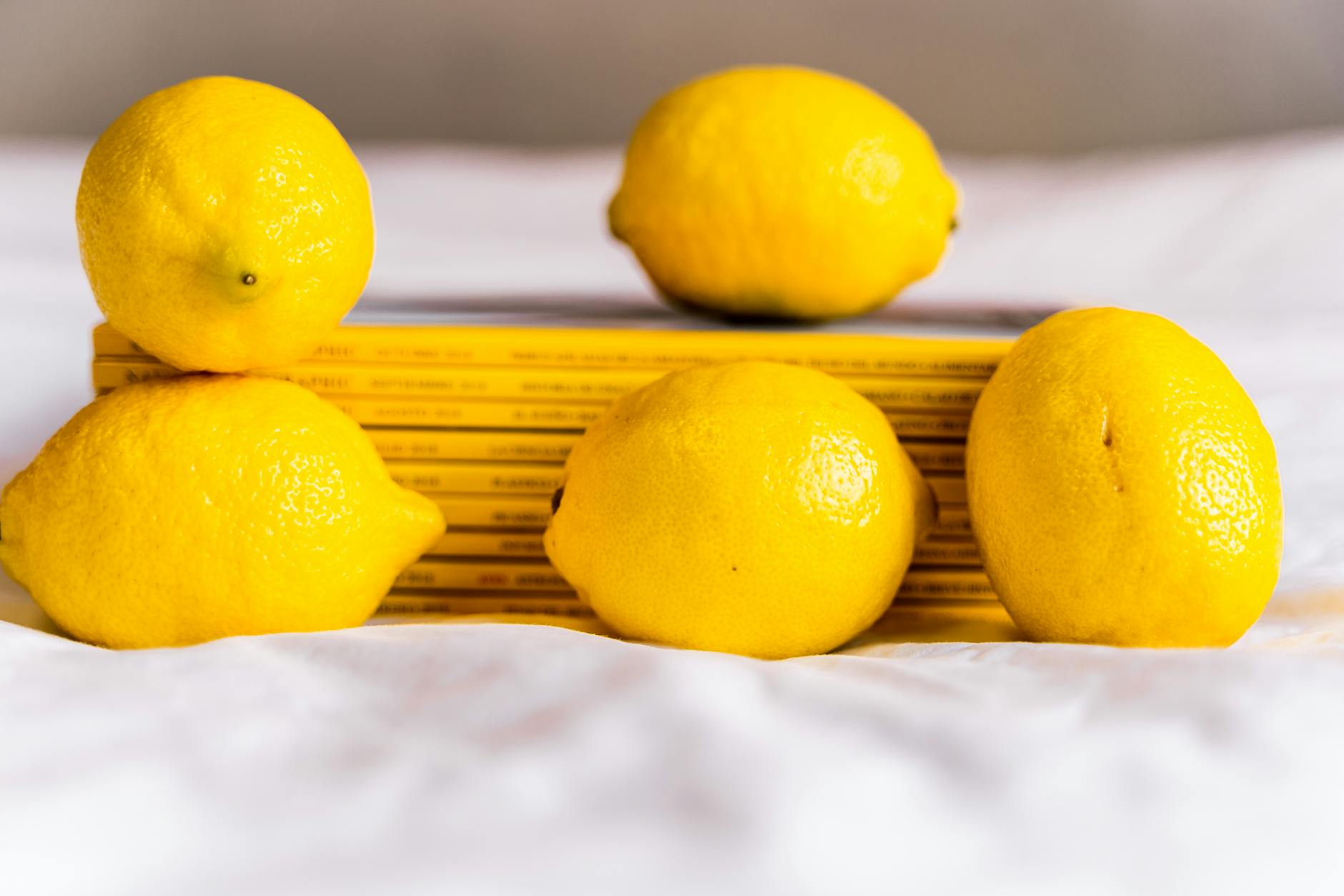 Fresh lemons arranged on white surface, symbolizing renewal and fresh starts